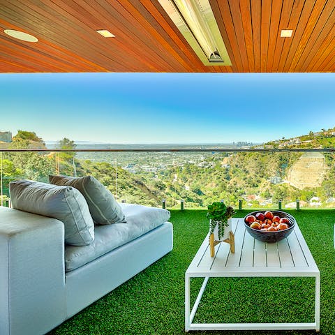 Lounge on the balcony while waiting for the sun to set over LA