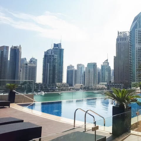 Swim in the communal pool with views across the marina