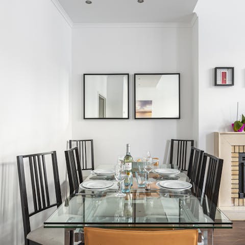 Enjoy a vibrant brunch around the glass dining table in your light-filled living space