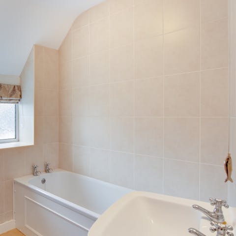 Unwind in the bathtub with a glass of wine in hand