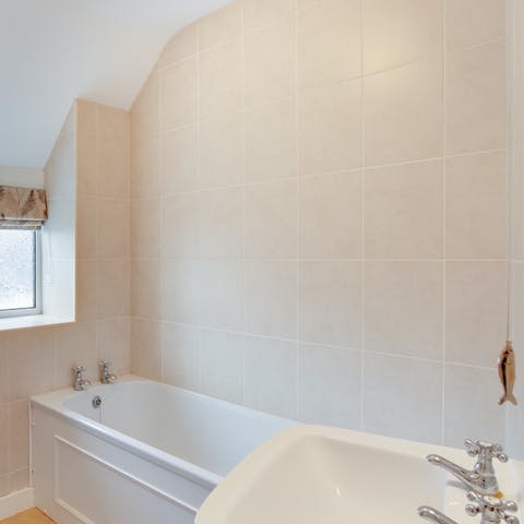Unwind in the bathtub with a glass of wine in hand