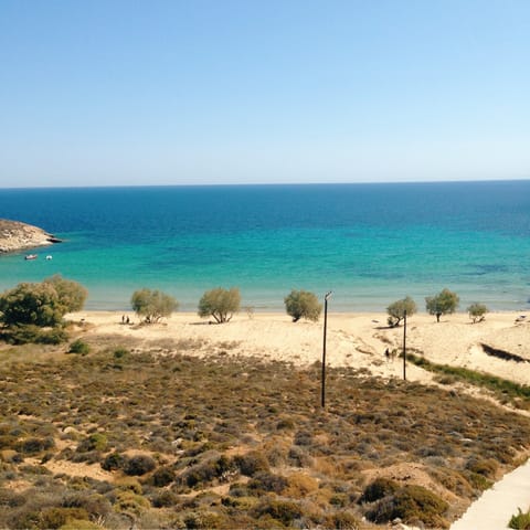 Get the sand between your toes at Livadi beach, only a ten–minute walk away