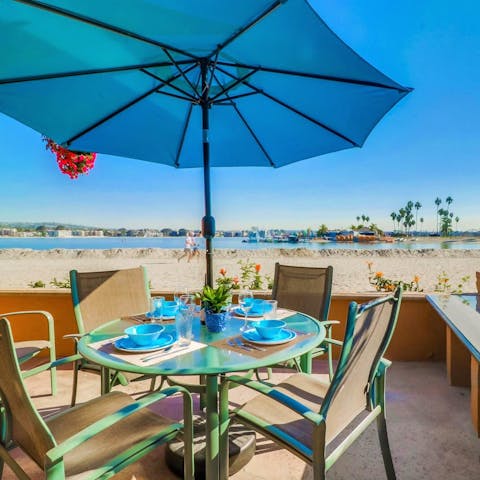 Share some food and drink on the sandy terrace