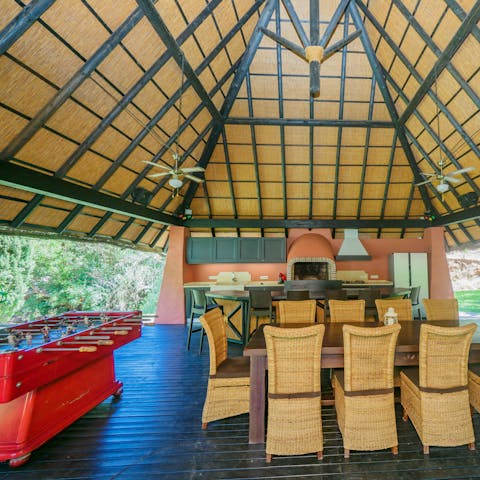 Hang out in the shared pagoda, featuring a bar, dining table and foosball table