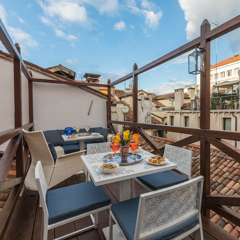 Sip Venetian wine out on the cosy rooftop terrace