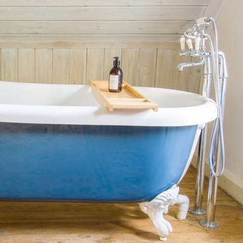 Soak away the day in the bedroom's roll top bath
