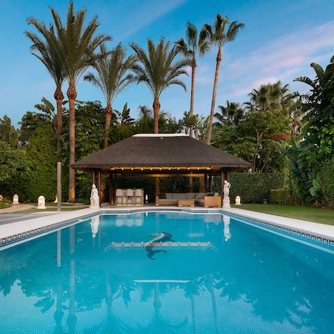 Spend your downtime floating in the pool and dining beneath the palm trees