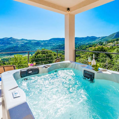 Take in the stunning mountain views while relaxing in the luxurious hot tub 