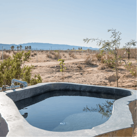 Marvel at the natural landscape while soaking in a  hot springs tub
