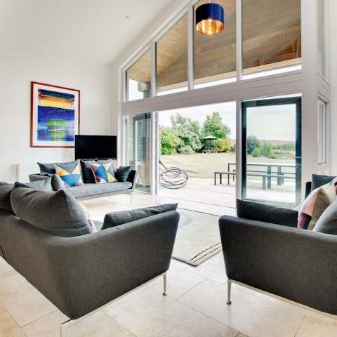 Unwind in the vast living area with a glass of wine, admiring the scenery from the picture windows