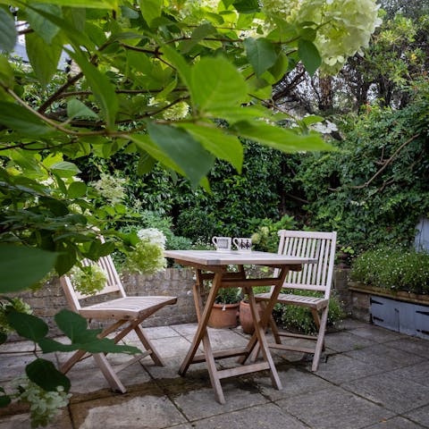 Bask in the summer sunshine with a cuppa in the quaint garden