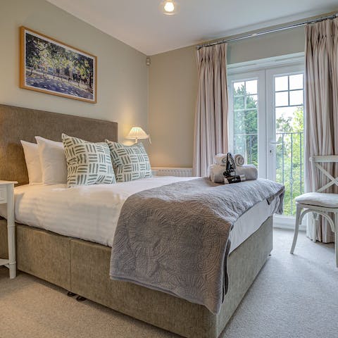 Wake up to green, leafy views through the bedroom's Juliet balcony windows