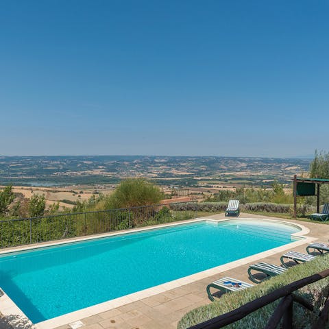 Enjoy a morning swim in the Roman-style pool overlooking the patchwork of countryside