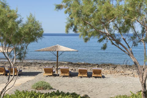 Catch some sun on the shared loungers by the water's edge