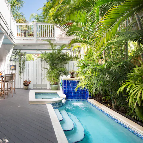 Step into the clear waters of the private pool amongst the lush palm leaves