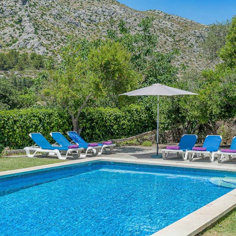Lounge by the poolside under the Tramuntana mountain range