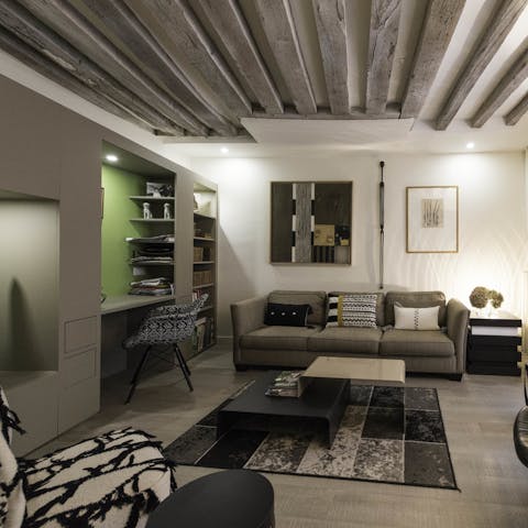 Relax on the cosy sofa under exposed wooden beams
