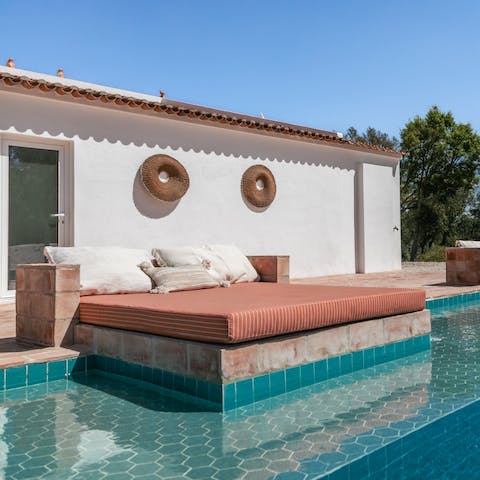 Spread out on your daybed, catching up on your book and soaking up the sun