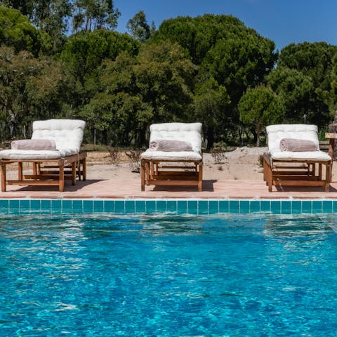 Relax on the plush sun loungers, taking in the natural surroundings before cooling off in your inviting pool
