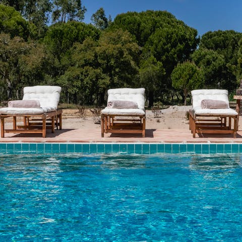 Relax on the plush sun loungers, taking in the natural surroundings before cooling off in your inviting pool