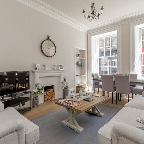 Get comfy in the charming living area, bathed in natural light streaming in through the windows 