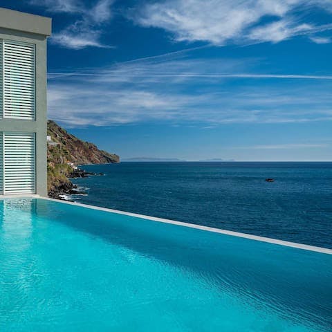 Take in the sea views from the communal infinity pool