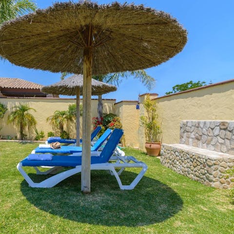 Laze on loungers in the sun or in the shade of the parasol