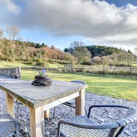 Enjoy a drink outside as the countryside stretches out before you