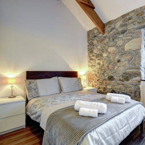 Wake in your comfortable bedroom with stunning stone walls, ready to embrace another day of adventure