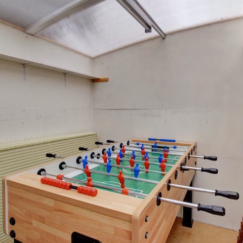 Challenge someone to a game of table football in the shed 