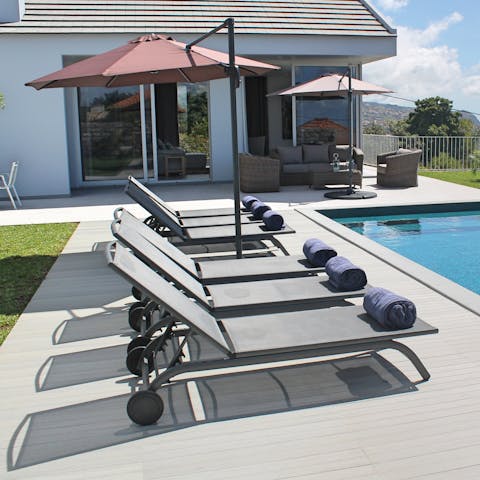 Soak up the sunshine from the poolside sun beds 