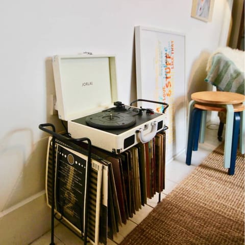 Select something from the vinyl collection and set the tone on the record player