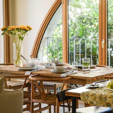Gather round the dining table and enjoy the natural light through the large windows as you tuck in