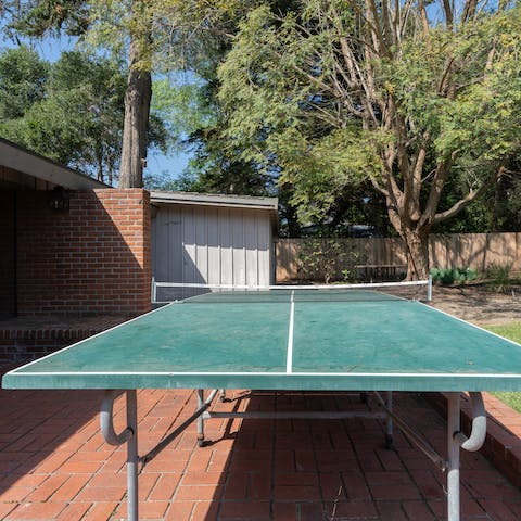 Set up a friendly game of table tennis in the sunshine