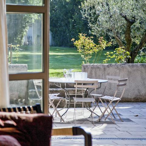 Enjoy drinks on your terrace, overlooking the vast gardens