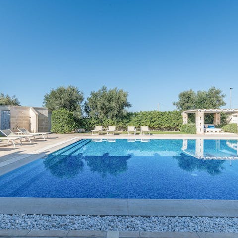 Swim laps of the outdoor pool or lounge poolside in the sun