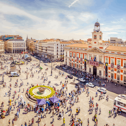 Visit bustling Puerta del Sol, a four-minute walk away