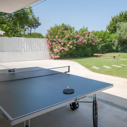 Enjoy a game of table tennis while the kids play in the garden