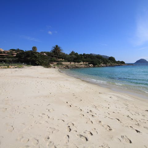 Spend a day on the sands of Spiaggia Baia Caddinas, a short walk away