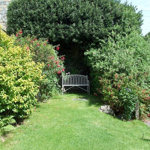 Curl up with a good book on the secluded bench in the garden