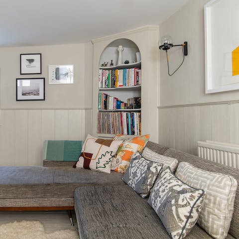 Sprawl out on the L-shaped sofa with a book from the host's collection