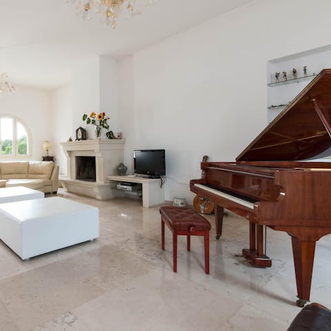 Treat guests to a sing-song around the grand piano in the living room
