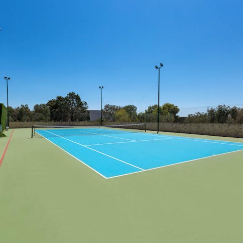 Show off your first serve on the home's private tennis court