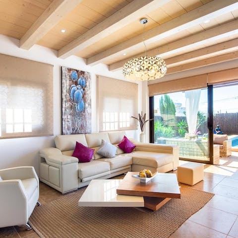 Relax in the sleek living space as the breeze blows through the open doors