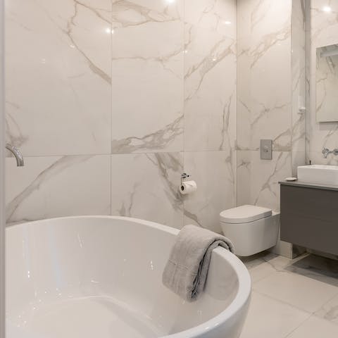 Unwind in the enormous free standing bathtub