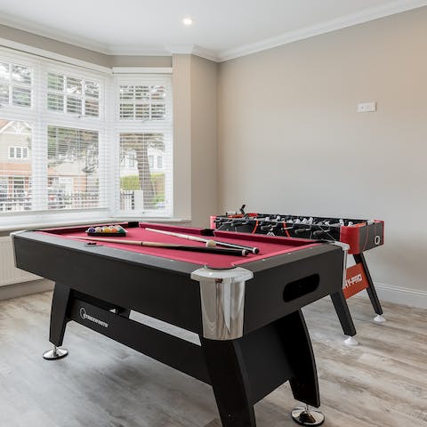 Get competitive in the games room featuring a pool table and table football