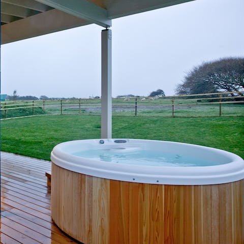 Soak in the hot tub while enjoying the tranquillity of the country setting 
