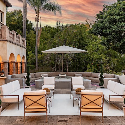 Enjoy a glass of wine out in the picturesque courtyard at sunset