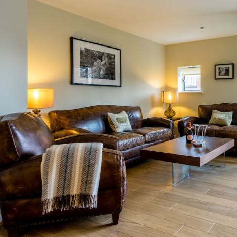Lounge comfortably on the leather sofas in the living area