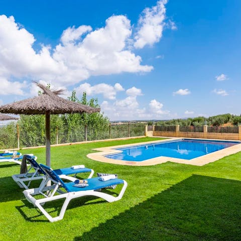 Laze on sun loungers in the garden before cooling off with a refreshing dip in your private outdoor pool